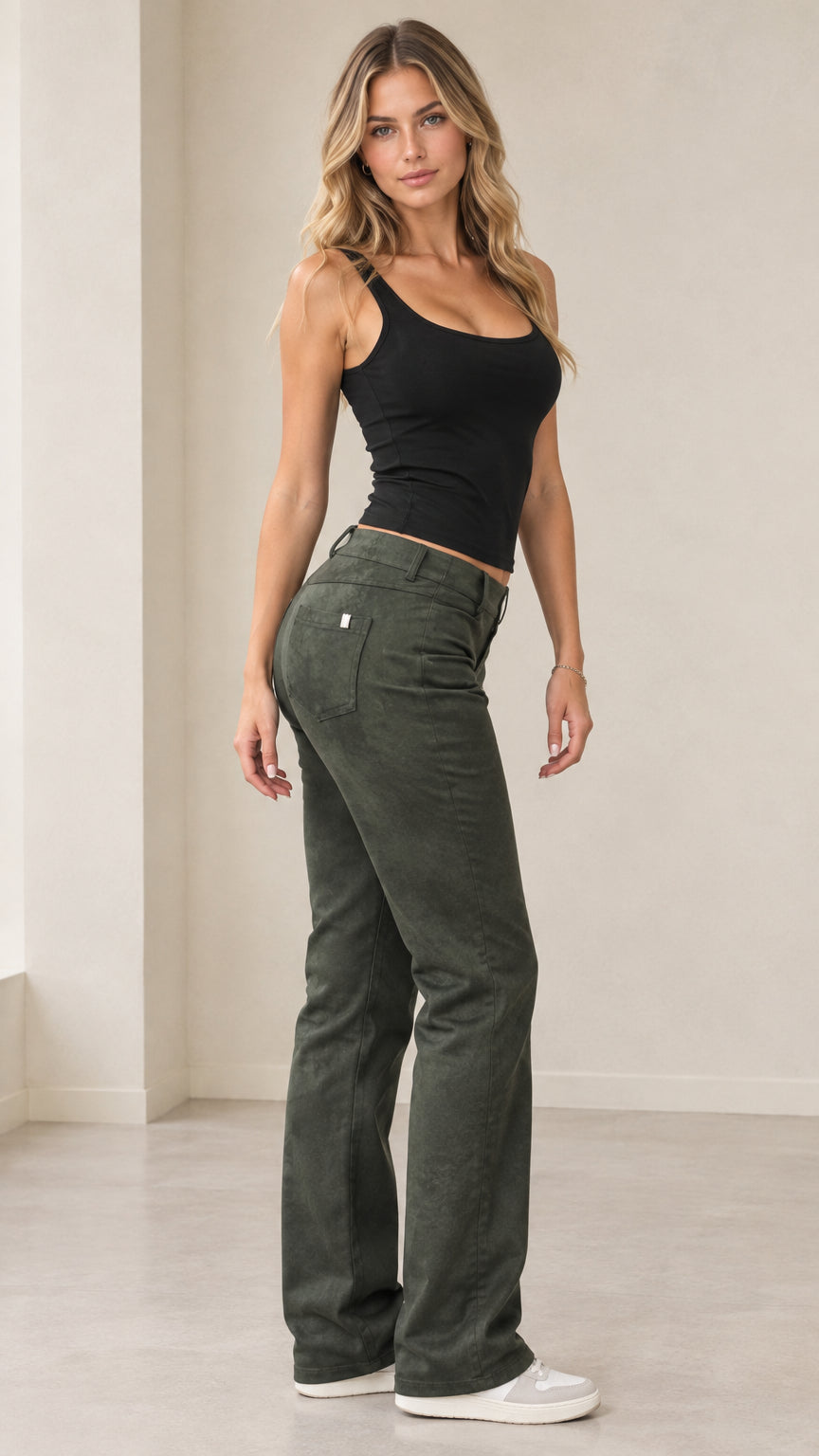 Full-length front three-quarter view of model wearing olive green textured bootcut pants