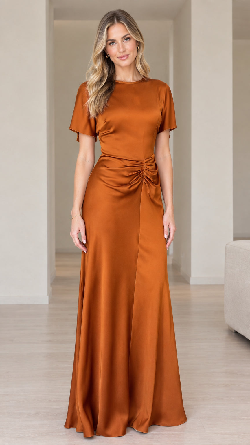 Front view of woman wearing rust orange short sleeve ruched satin maxi dress