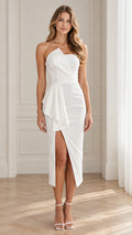 Front view of model wearing white strapless asymmetrical ruffle midi dress with front slit