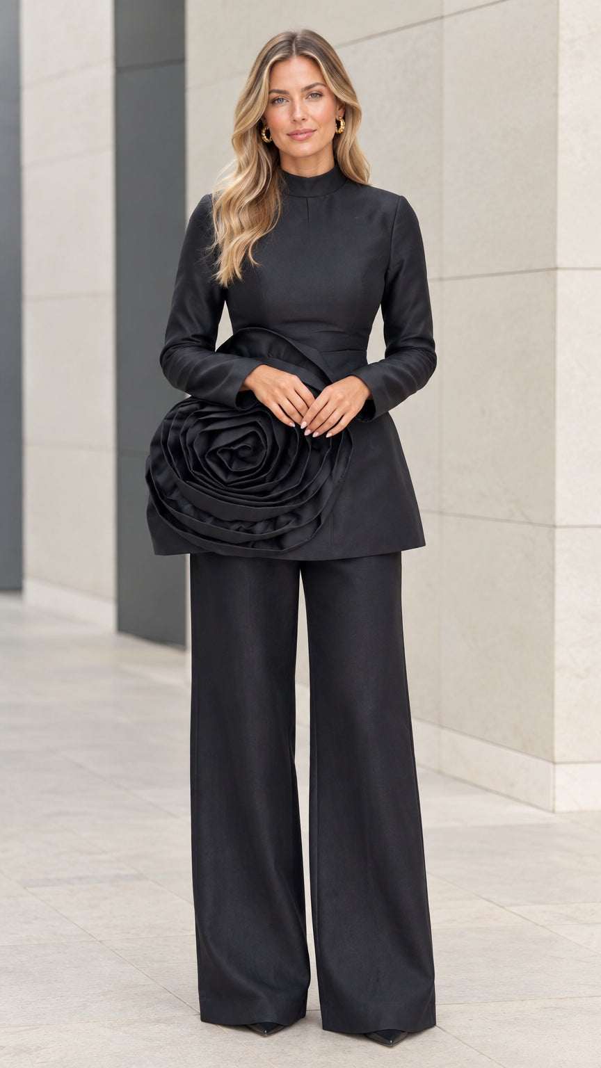 Front view of black high neck long sleeve tunic top with 3D rosette accent and wide leg pants