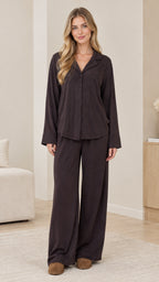 Front full-length view of model wearing dark brown long sleeve button-down pajama set with wide-leg pants