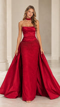 Front view of model wearing a red strapless ruched evening gown with beaded detail and dramatic train