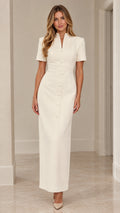 Front full view of woman wearing ivory tailored split neck column maxi dress
