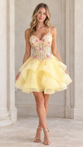 Front view of model wearing a yellow floral embroidered corset tiered mini dress