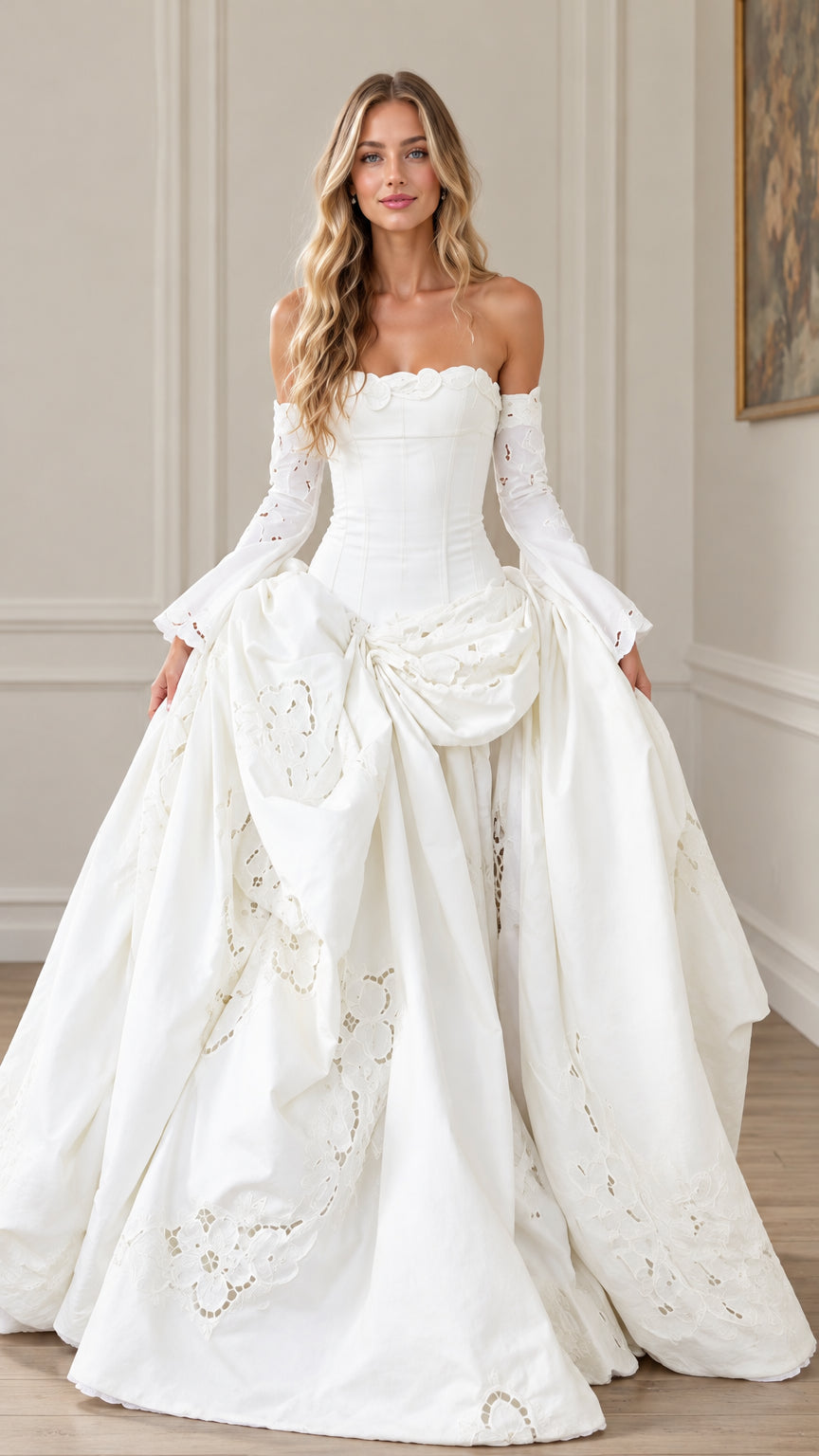 Front view of woman wearing white off-the-shoulder corset ball gown with draped embroidered skirt