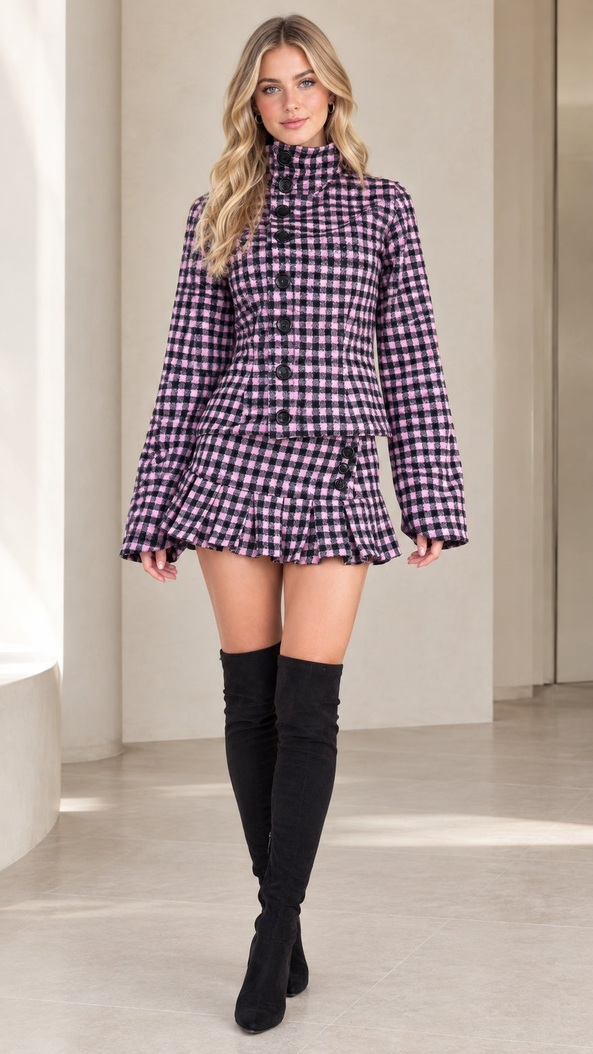 Front full view of woman wearing purple plaid high-neck jacket and pleated mini skirt set with knee-high boots