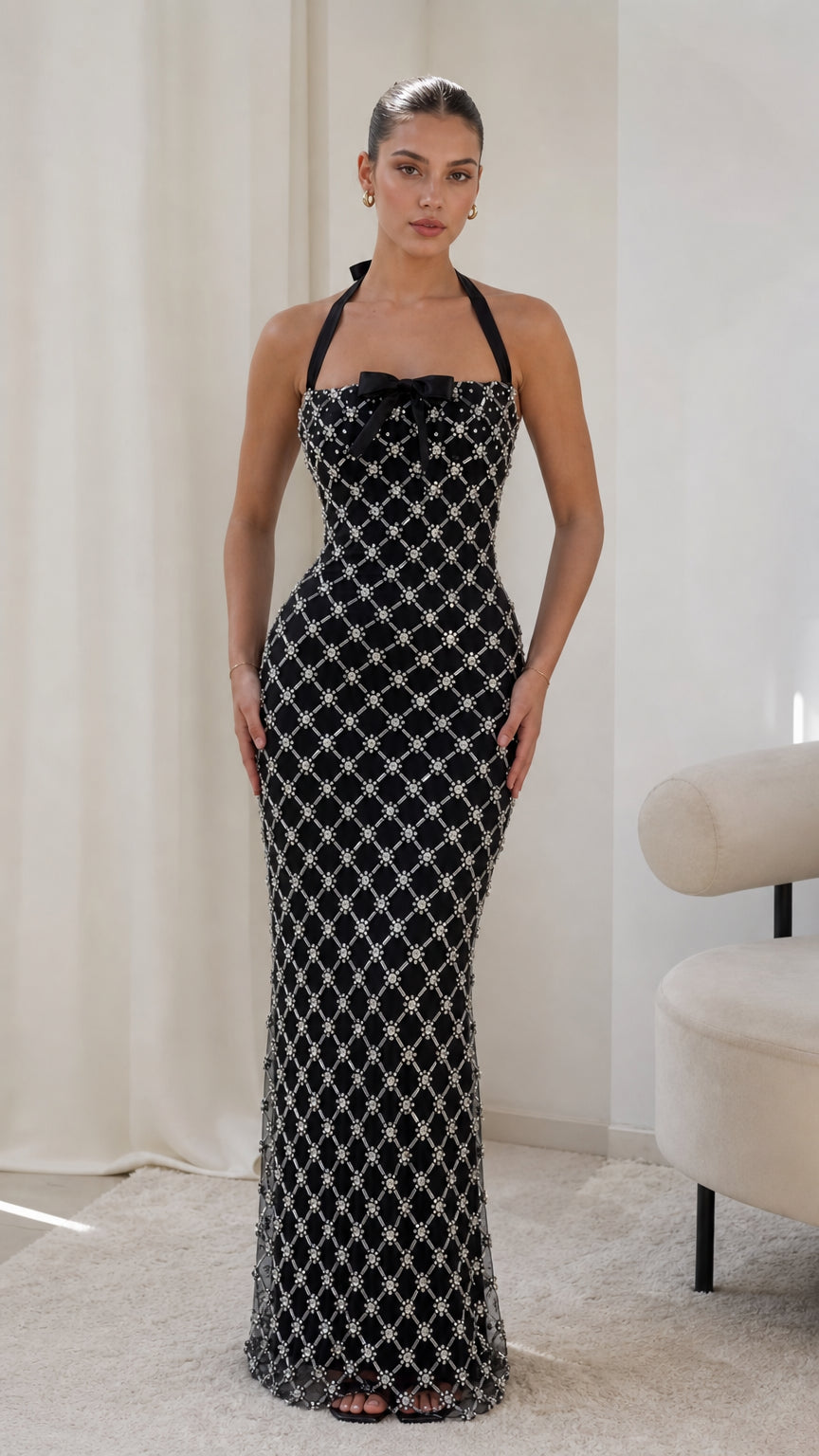Front view of model wearing black embellished lattice halterneck maxi dress