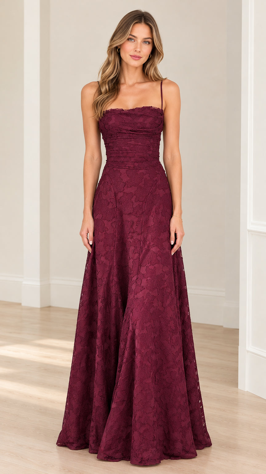 Front full-length view of model wearing burgundy floral lace maxi evening gown with ruched bodice and spaghetti straps