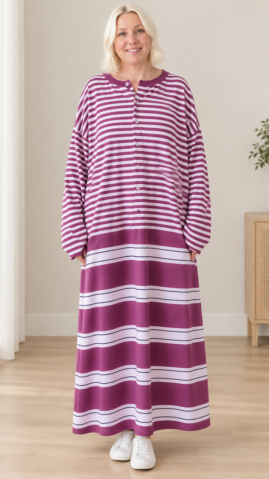 Front view of woman wearing purple striped long sleeve henley maxi dress