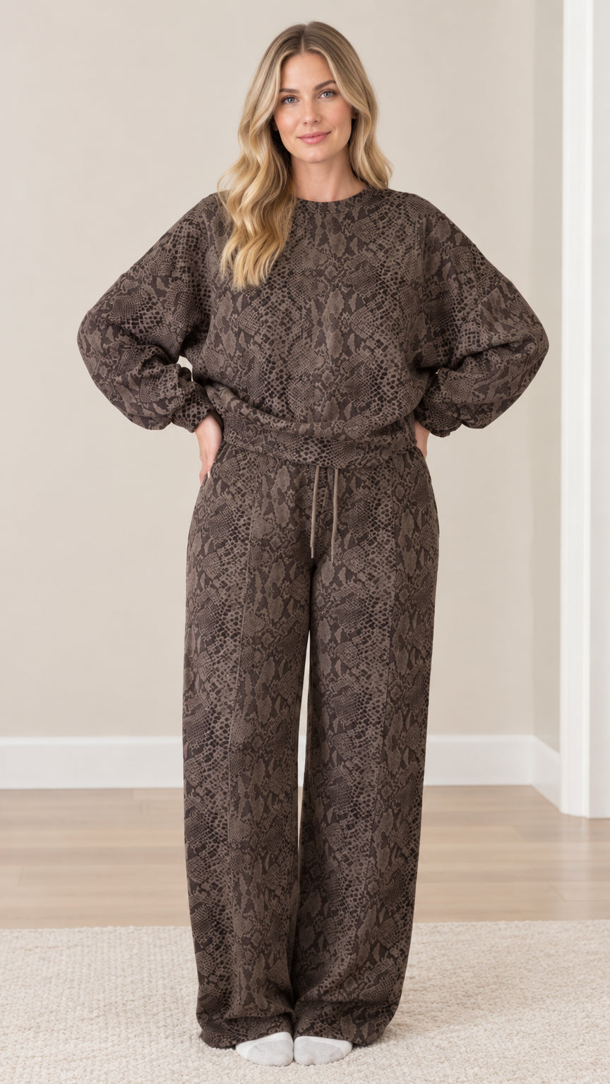 Full front view of model wearing brown snakeskin print long sleeve top and matching wide leg lounge pants