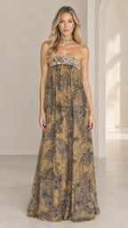 Front full view of woman wearing strapless golden tan floral print empire waist maxi dress