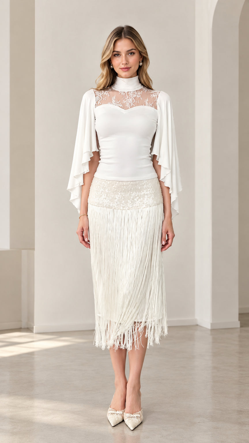 Front view of model wearing white lace yoke capelet top and fringe midi skirt set