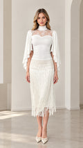 Front view of model wearing white lace yoke capelet top and fringe midi skirt set