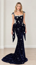 Front full-length view of navy blue velvet evening gown with crystal star embellishments and sweeping train