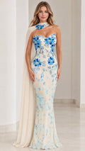 Front full view of ivory mermaid evening gown with blue floral embroidery and attached chiffon cape
