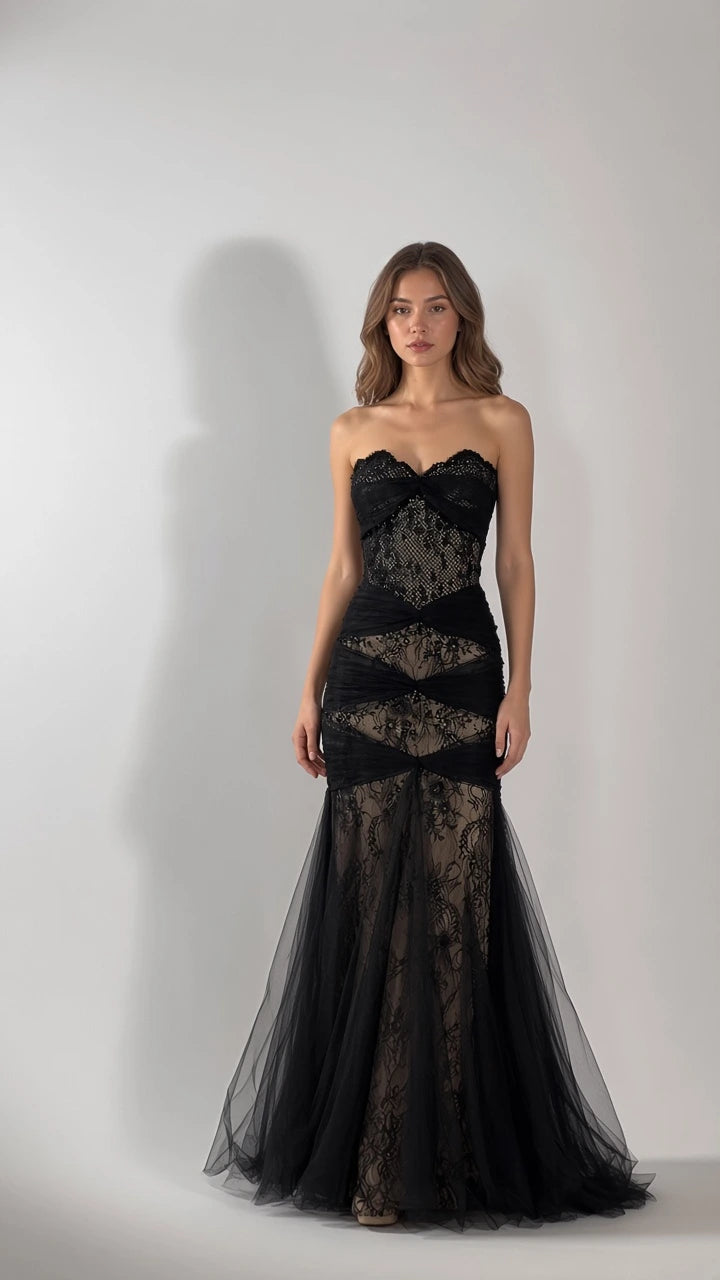 Front full-length view of woman wearing strapless black lace corset mermaid gown