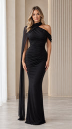 Front view of model wearing black asymmetrical cape neckline ruched maxi dress