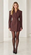 Front view of woman wearing brown tailored cinched waist blazer mini dress with black heels