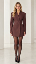 Front view of woman wearing brown tailored cinched waist blazer mini dress with black heels