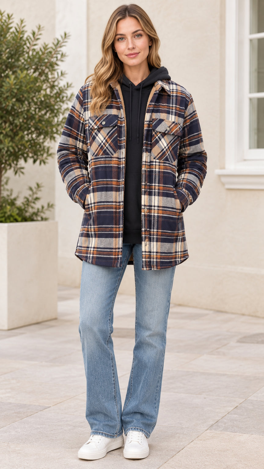 Front view of model wearing Navy fleece-lined plaid hooded shacket jacket with flared jeans
