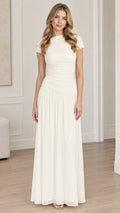 Front full-length view of woman wearing ivory ruched bodice drop-waist maxi dress