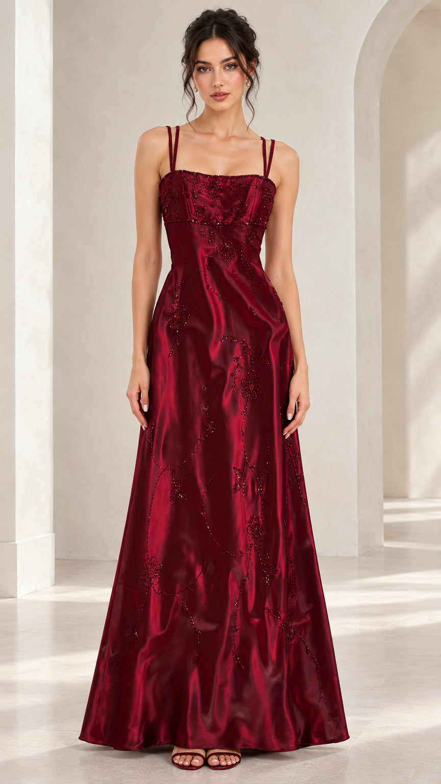 Front full-length view of woman wearing burgundy double strap beaded satin A-line evening maxi gown