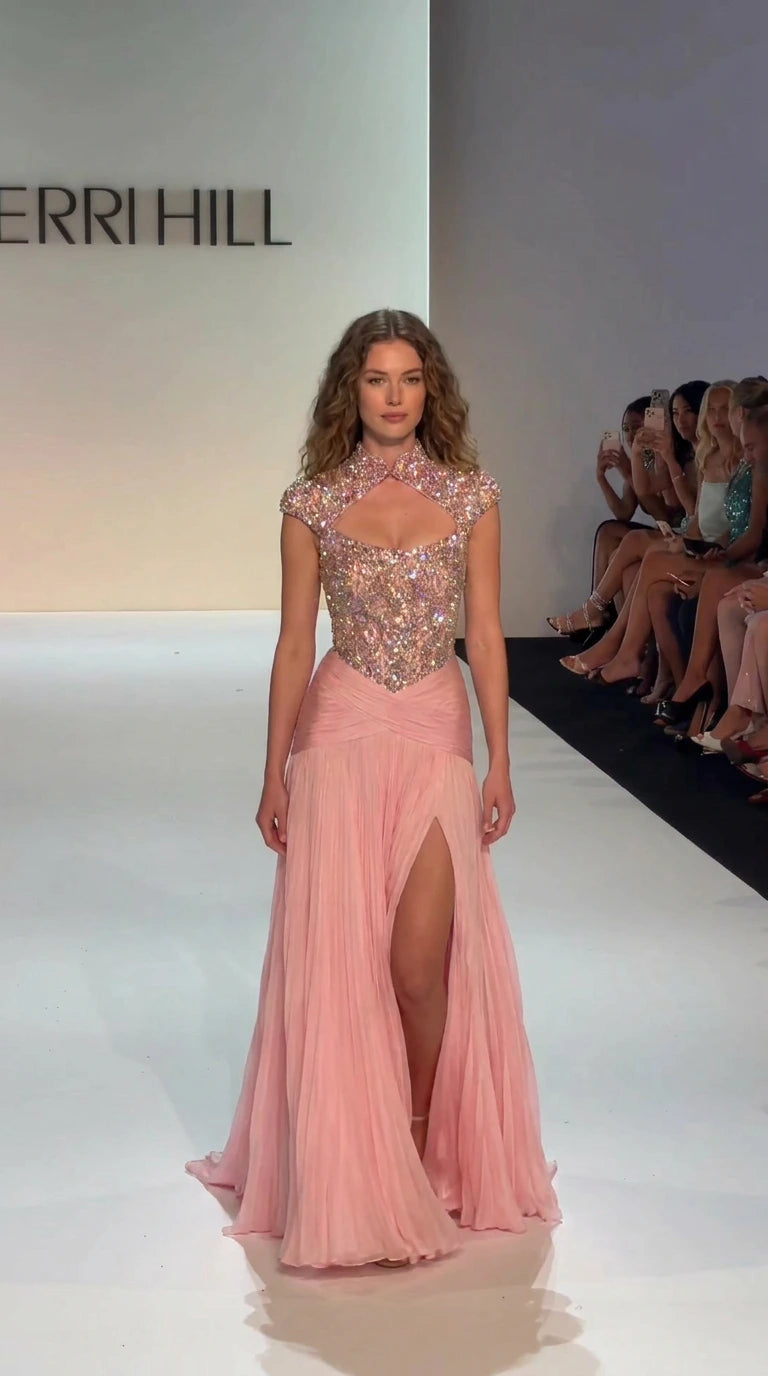 Blush pink embellished high-neck evening gown with keyhole cutout and pleated skirt on runway