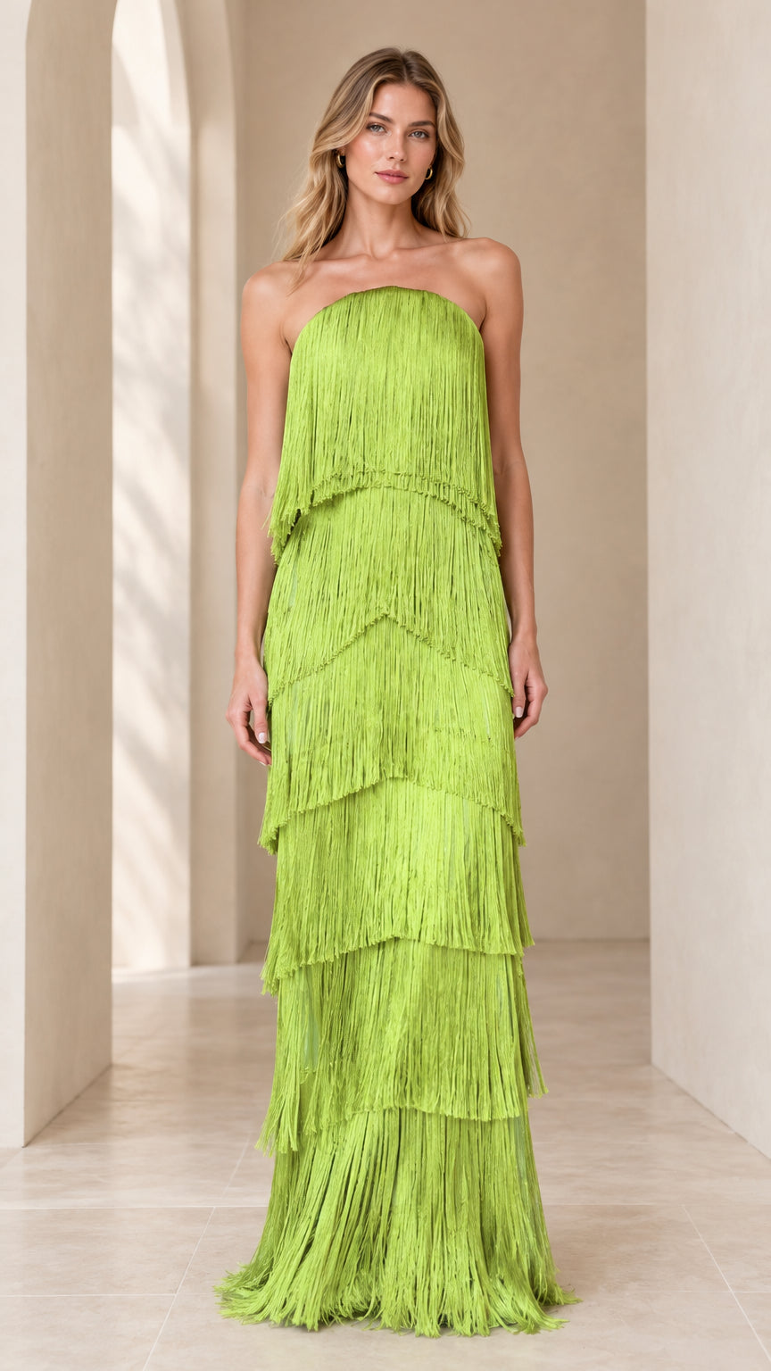 Front full-length view of model wearing lime green strapless tiered fringe maxi dress