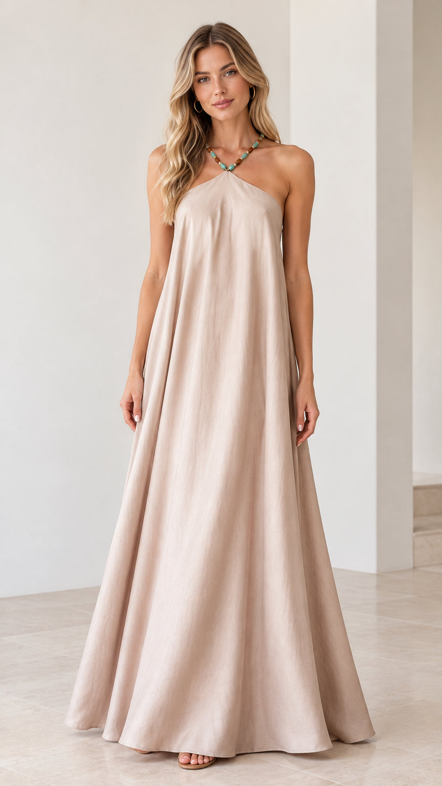 Front view of model wearing beige beaded halter backless maxi dress