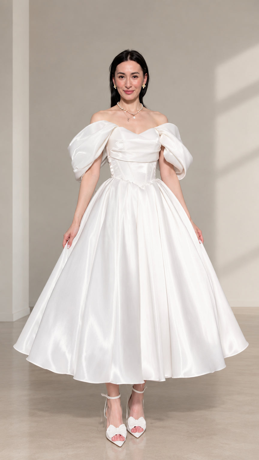 Front view of woman wearing white off-the-shoulder puff sleeve corset midi dress