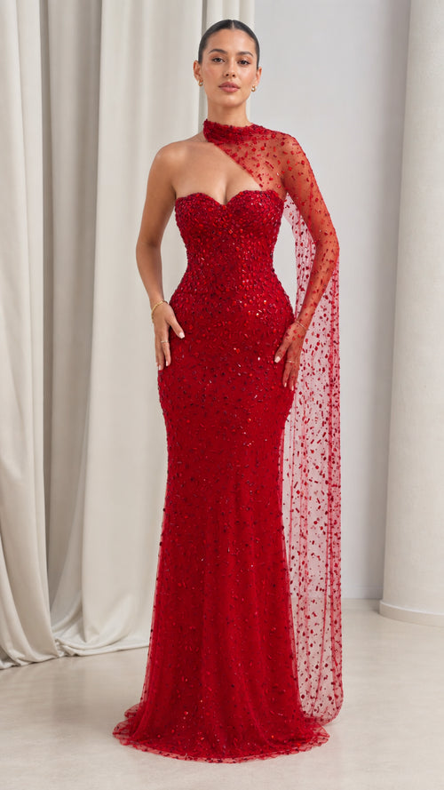 Front view of model wearing red asymmetrical beaded cape sleeve evening gown