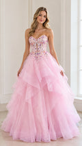 Front view of woman wearing a pink strapless tiered tulle ball gown with beaded bodice