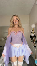 Front view of model wearing lavender floral corset mini dress with draped sleeves