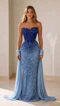 Front view of a royal blue sequin mermaid evening gown with strapless sweetheart neckline and pale blue draped accents