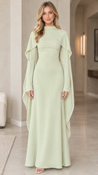 Front view of woman wearing sage green high-neck pearl-trimmed cape sleeve maxi evening dress