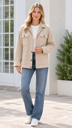Front view of model wearing beige textured button-front shirt jacket with jeans