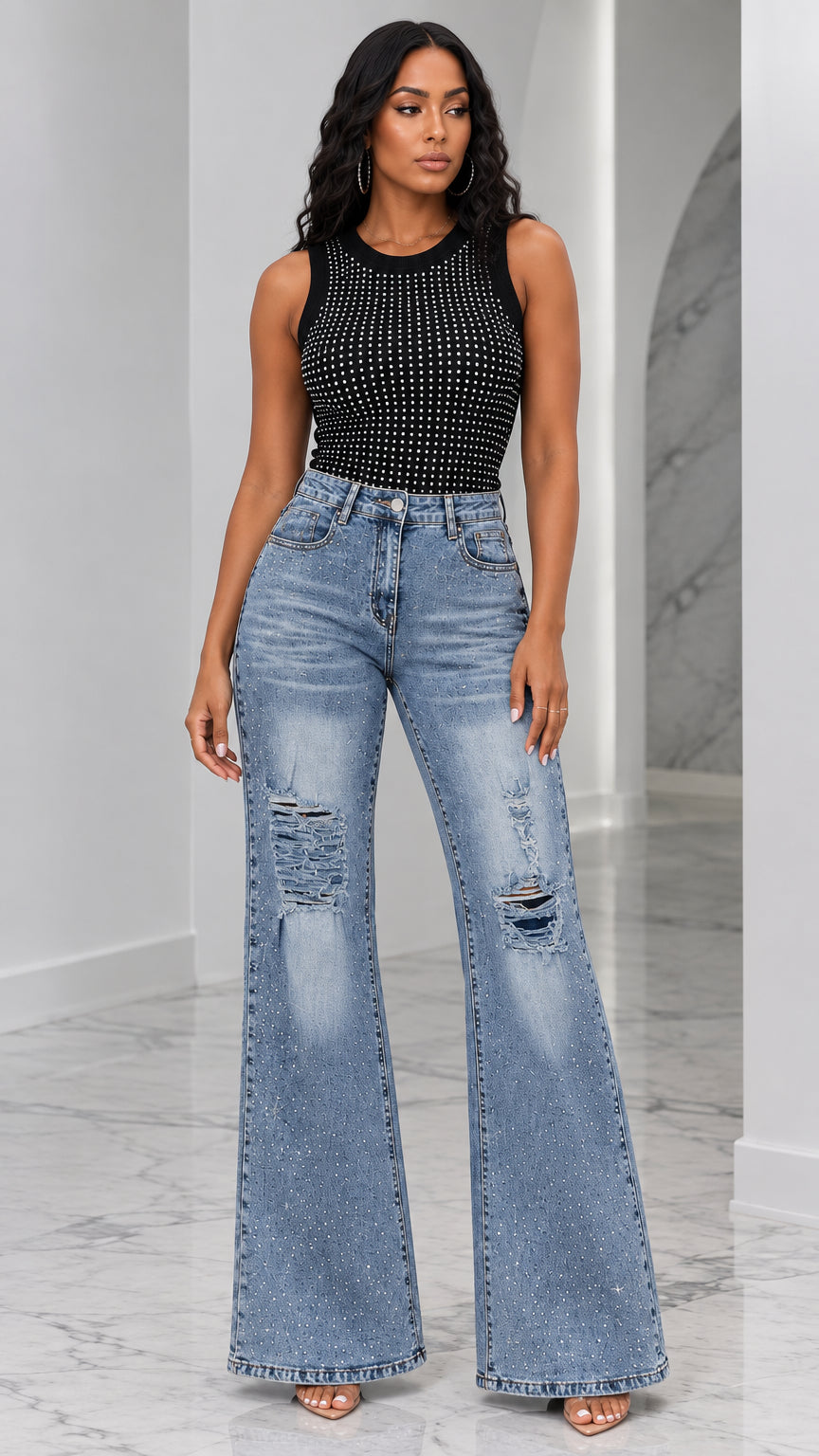 Front full view of woman wearing black rhinestone tank top and blue distressed flare jeans set