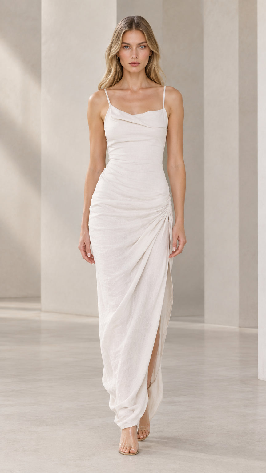 Front full-length view of model wearing white cowl neck ruched maxi dress with high side slit