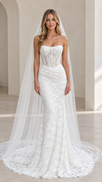 Front view of model wearing white strapless sheer corset mermaid wedding gown with long veil