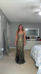 Front view of woman wearing black and gold sequin evening gown with front slit