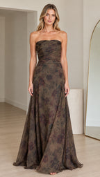 Front view of woman wearing strapless olive floral maxi gown