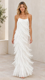 Front full-length view of woman wearing white tiered fringe spaghetti strap maxi dress