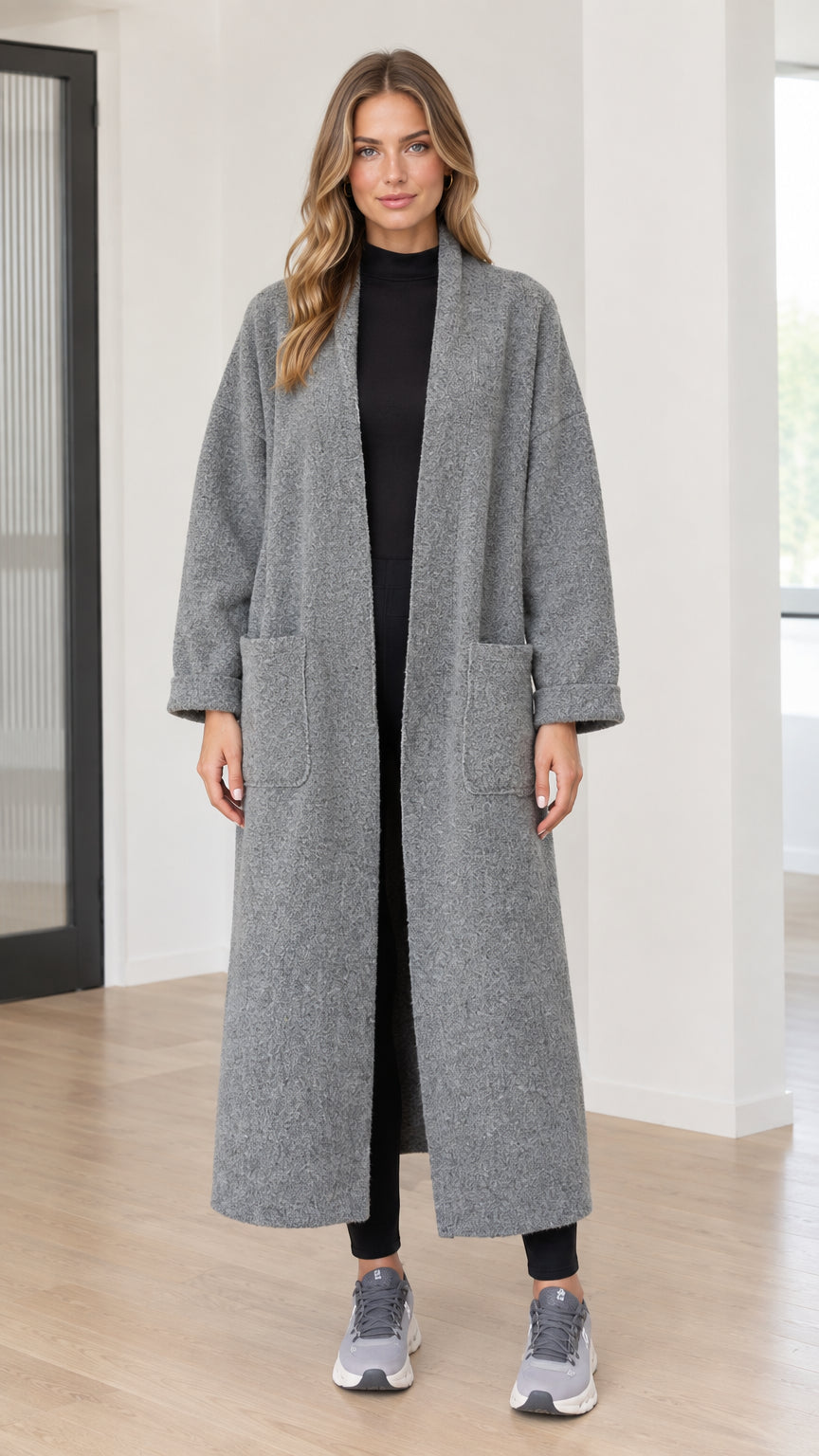 Front full-length view of model wearing grey textured bouclé long open front duster coat