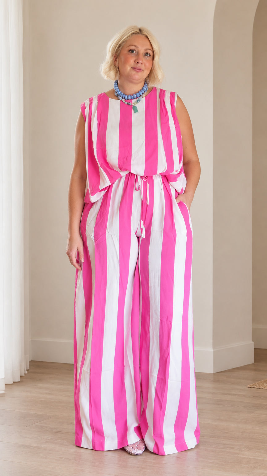 Front full view of woman wearing pink and white striped sleeveless top and matching wide leg pants set