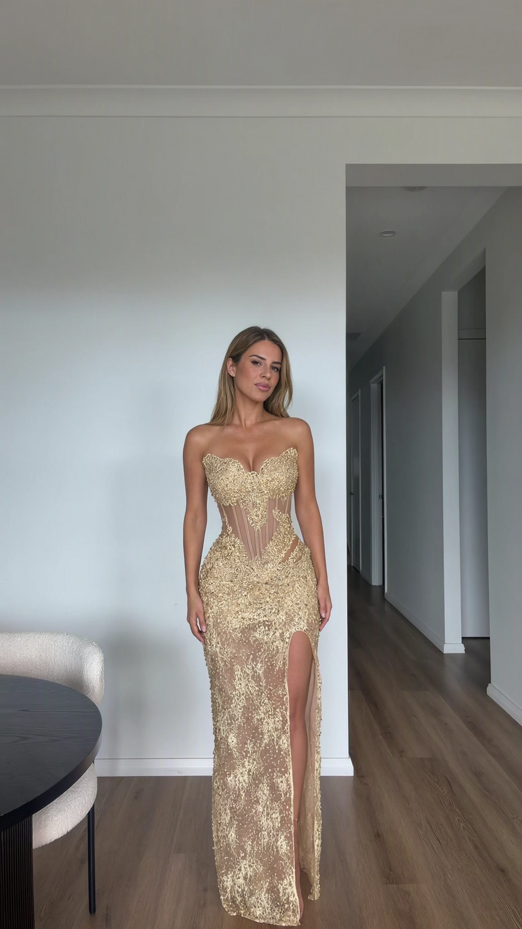 Full front view of model wearing Champagne Gold embroidered lace corset evening gown with high slit