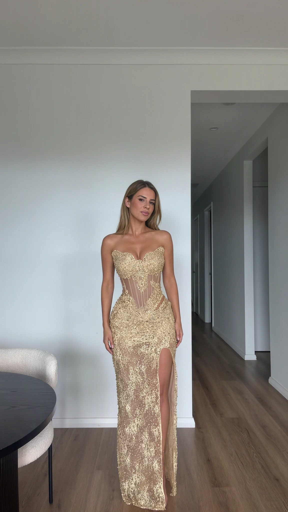 Full front view of model wearing Champagne Gold embroidered lace corset evening gown with high slit