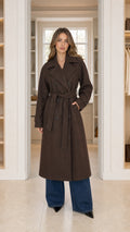 Front view of model wearing chocolate brown double-breasted long belted overcoat