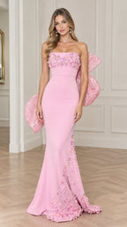 Front full view of woman wearing strapless pink mermaid evening gown with floral appliqué and back bow
