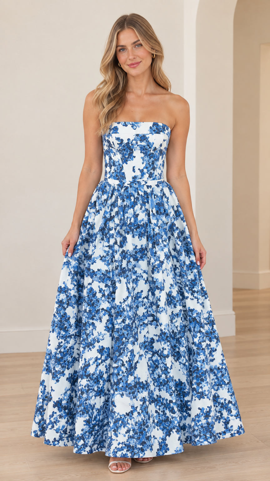 Front view of woman wearing strapless white and blue floral A-line maxi gown