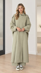 Front full-length view of model wearing sage green oversized maxi duster trench coat